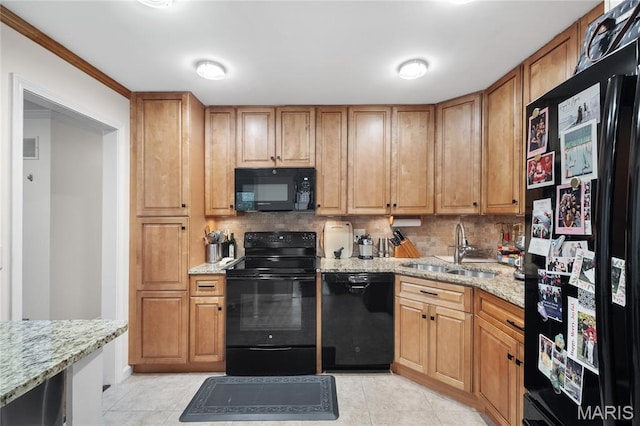 5567 Waterman Blvd Unit D, Saint Louis, MO 63112 - kitchen featuring black appliances, a sink, light tile patterned floors, decorative backsplash, and light stone countertops