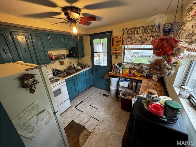 895 Parkway Dr, Bismarck, MO 63624 - kitchen featuring white appliances, a sink, a ceiling fan, light countertops, and light tile patterned flooring