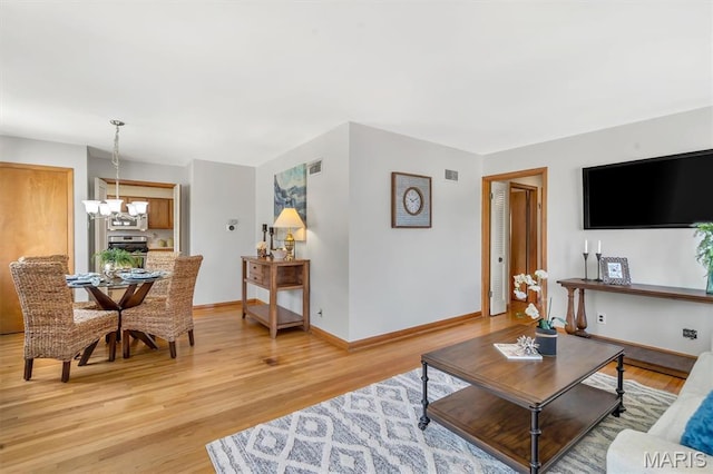 10710 Winthrop Ct, Saint Louis, MO 63123 - living area featuring light wood-style floors and a chandelier