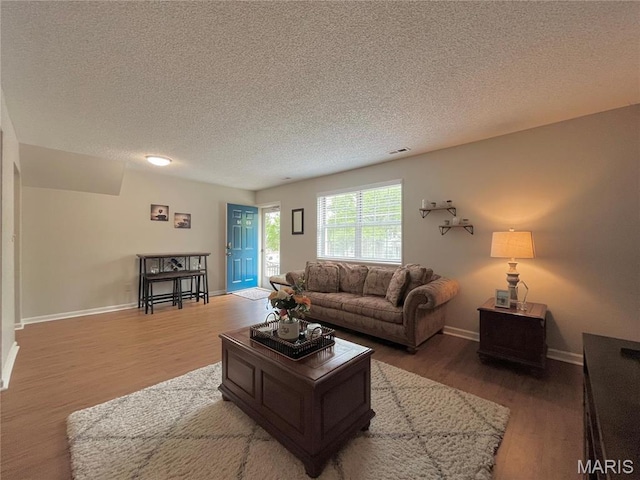 9169 N Swan Cir, Brentwood, MO 63144 - living room featuring light wood-style floors, a textured ceiling, and baseboards