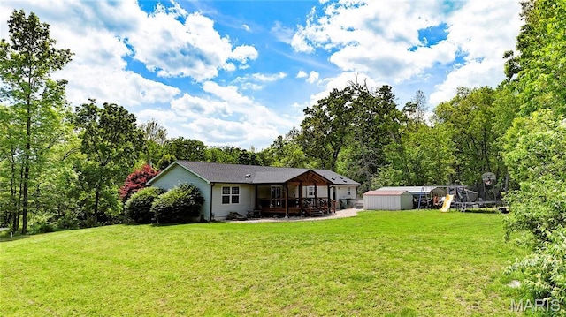 4311 Lakeview Dr, Hillsboro, MO 63050 - rear view of house with a storage unit, a wooden deck, an outbuilding, and a lawn