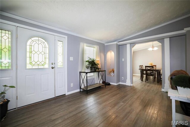 4311 Lakeview Dr, Hillsboro, MO 63050 - foyer featuring dark wood finished floors, plenty of natural light, arched walkways, a chandelier, and crown molding