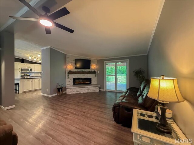 4311 Lakeview Dr, Hillsboro, MO 63050 - living room featuring crown molding, lofted ceiling, a ceiling fan, a stone fireplace, and dark wood-style flooring