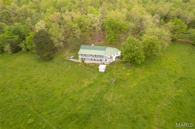 view of subject property with a forest