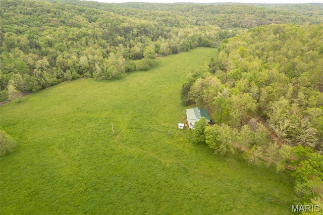 view from above of property with a heavily wooded area