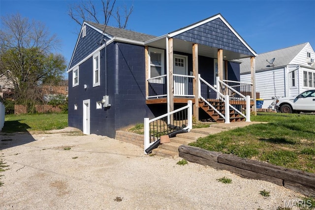 721 Woodland Ave, Festus, MO 63028 - view of front of property featuring stairs, covered porch, a front lawn, and concrete block siding