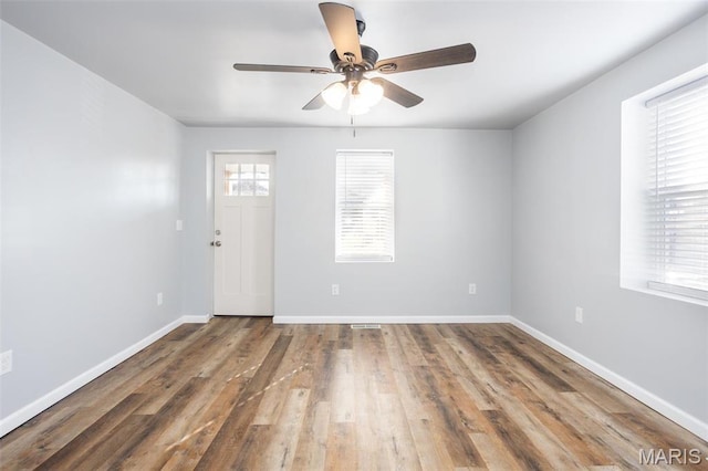 721 Woodland Ave, Festus, MO 63028 - unfurnished room with ceiling fan, wood finished floors, and baseboards
