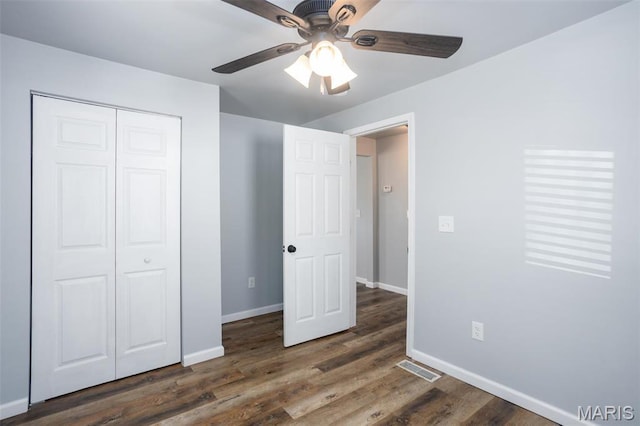 721 Woodland Ave, Festus, MO 63028 - unfurnished bedroom featuring baseboards, a closet, wood finished floors, and a ceiling fan