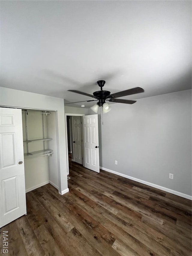 721 Woodland Ave, Festus, MO 63028 - unfurnished bedroom featuring a closet, baseboards, dark wood-style flooring, and ceiling fan