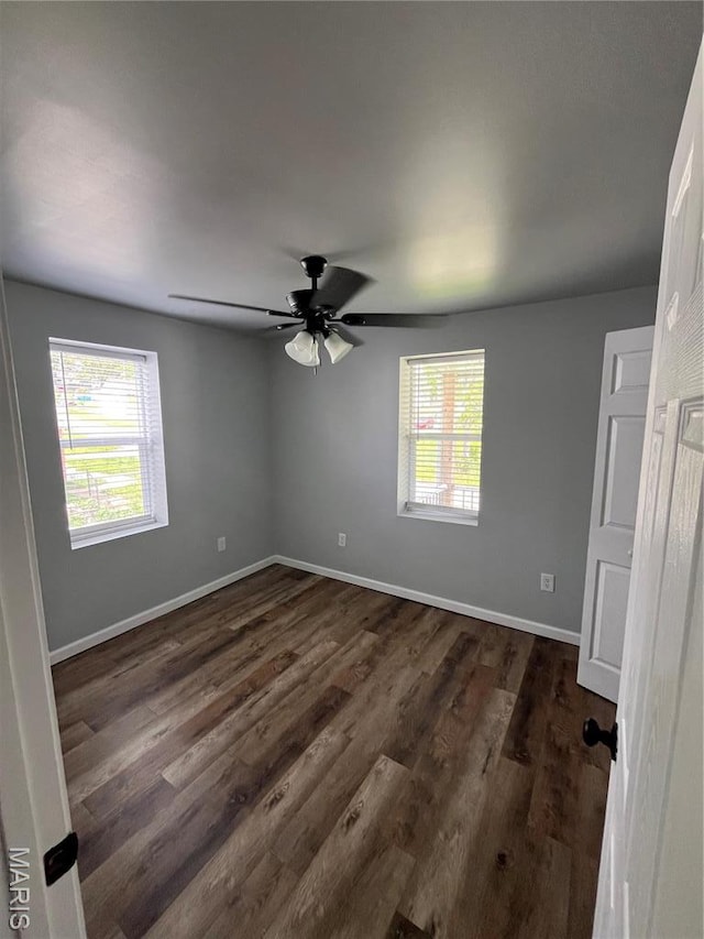 721 Woodland Ave, Festus, MO 63028 - spare room with baseboards, dark wood finished floors, and ceiling fan