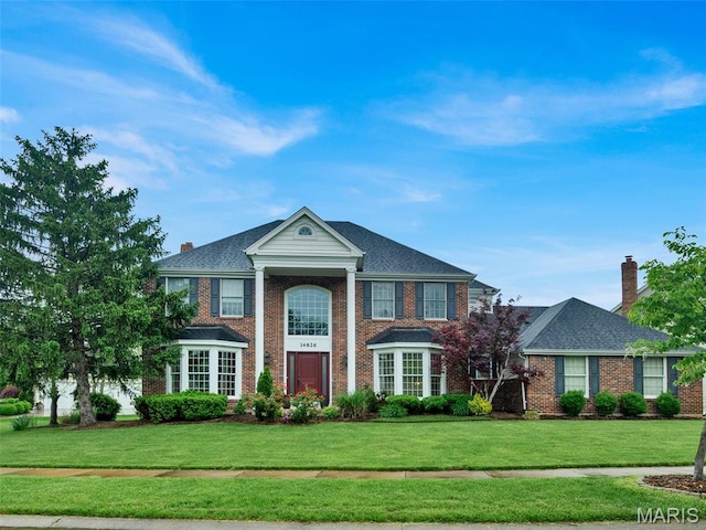 14826 Straub Hill Ln, Chesterfield, MO 63017 - view of front of home featuring a front lawn, a chimney, and brick siding