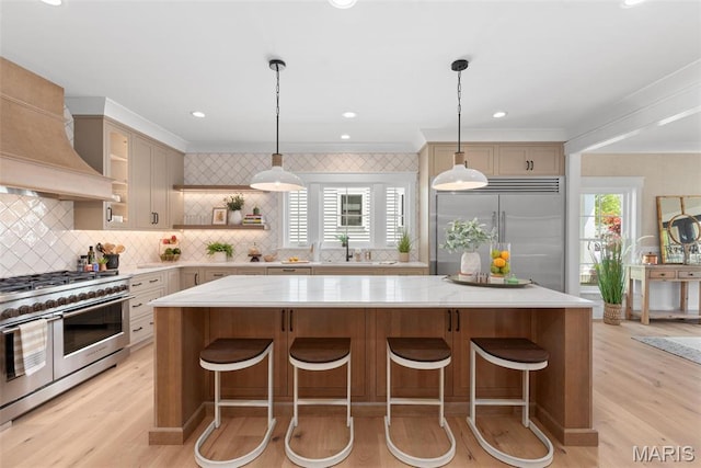 601 Foote Ave, Webster Groves, MO 63119 - kitchen featuring premium appliances, a center island, decorative backsplash, light wood-style floors, and open shelves