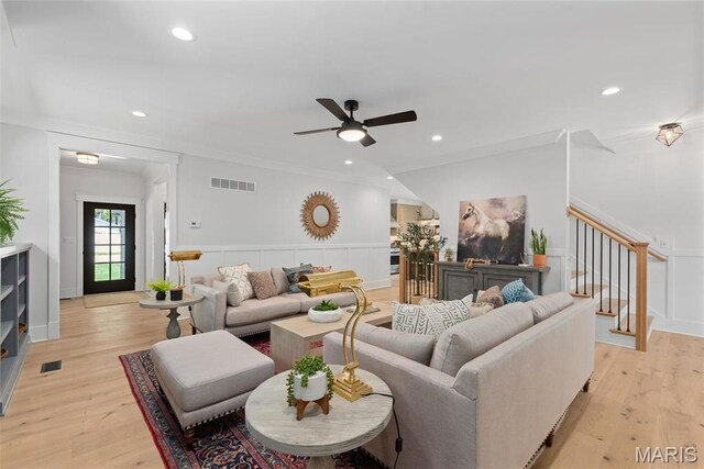 601 Foote Ave, Webster Groves, MO 63119 - living area featuring stairway, wainscoting, ceiling fan, a decorative wall, and light wood-style floors