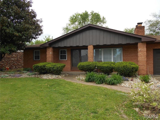 2408 Morrison Rd, Granite City, IL 62040 - single story home with brick siding, a front lawn, an attached garage, and a chimney