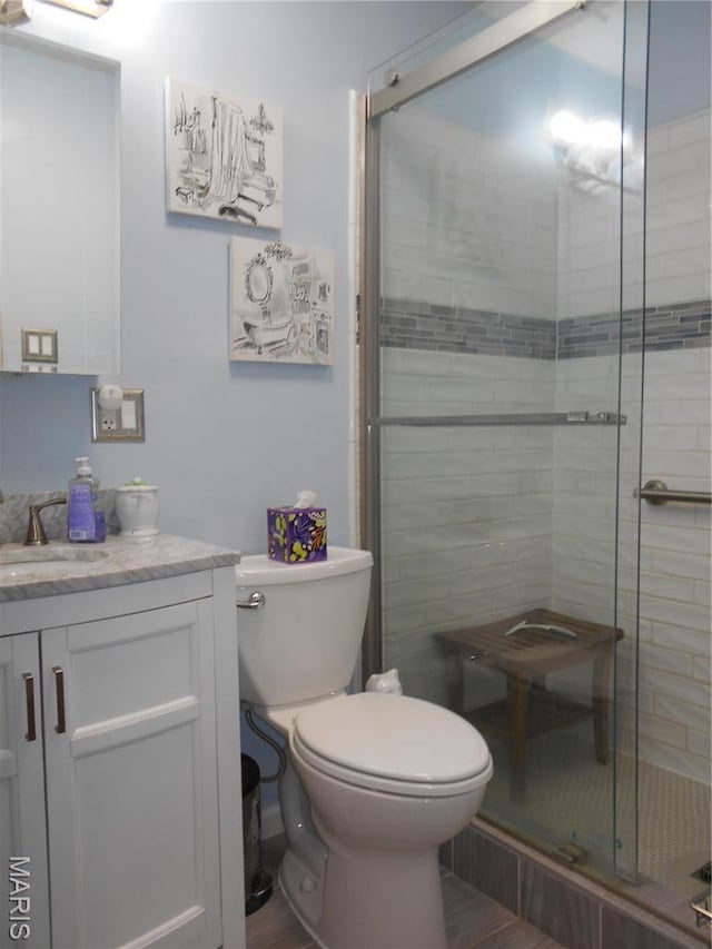 2408 Morrison Rd, Granite City, IL 62040 - bathroom featuring a shower stall, toilet, vanity, and wood finished floors