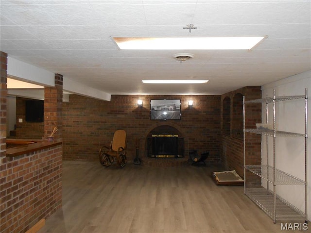 2408 Morrison Rd, Granite City, IL 62040 - finished below grade area featuring wood finished floors, a fireplace, and brick wall
