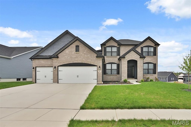 112 Westhaven View Dr, Wentzville, MO 63385 - french country style house featuring a garage, concrete driveway, brick siding, and a front yard