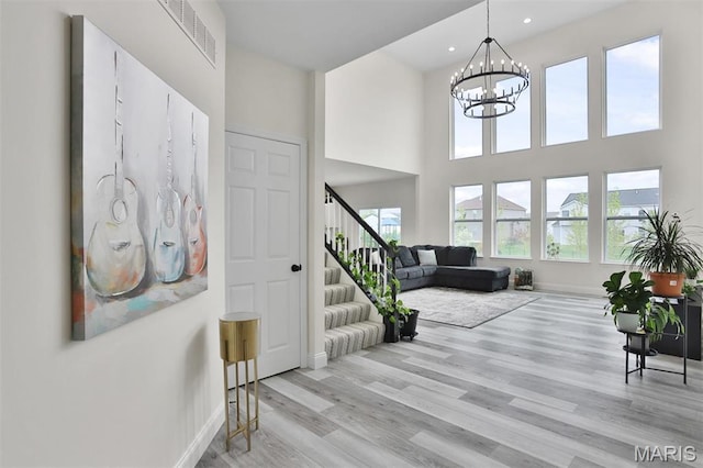 112 Westhaven View Dr, Wentzville, MO 63385 - entrance foyer with baseboards, stairway, light wood-style floors, a chandelier, and recessed lighting