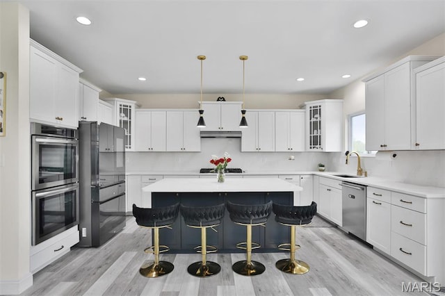 112 Westhaven View Dr, Wentzville, MO 63385 - kitchen with appliances with stainless steel finishes, a center island, a sink, white cabinetry, and recessed lighting