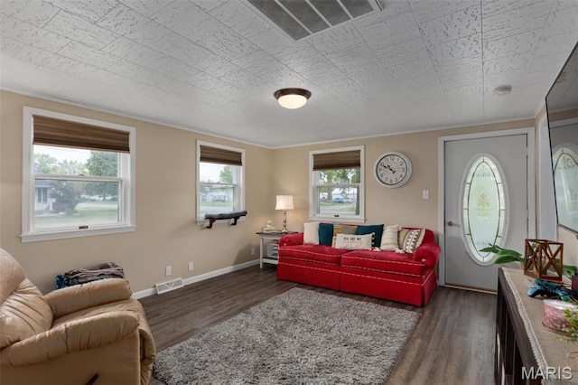 living area featuring dark wood-style floors, baseboards, and ornamental molding