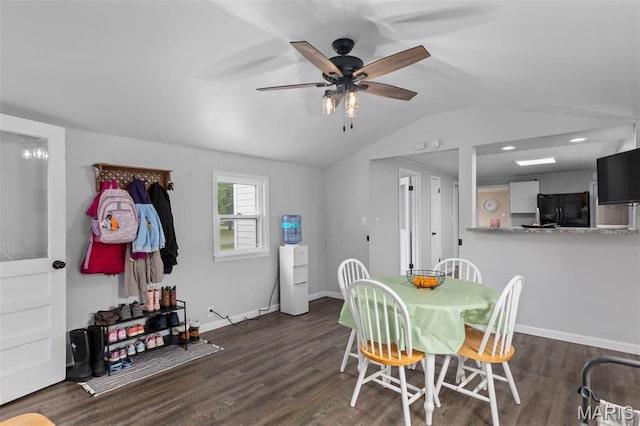 dining room featuring lofted ceiling, a ceiling fan, wood finished floors, and baseboards