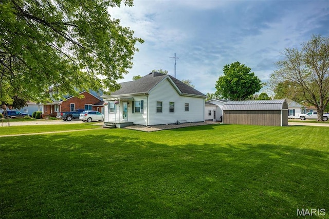 back of house with a lawn