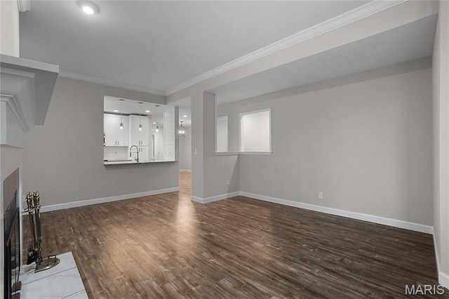 4250 Lindell Blvd Unit A, Saint Louis, MO 63108 - unfurnished living room with a fireplace with flush hearth, dark wood-style floors, crown molding, baseboards, and a sink
