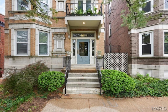 4250 Lindell Blvd Unit A, Saint Louis, MO 63108 - view of exterior entry featuring a balcony, brick siding, and stone siding