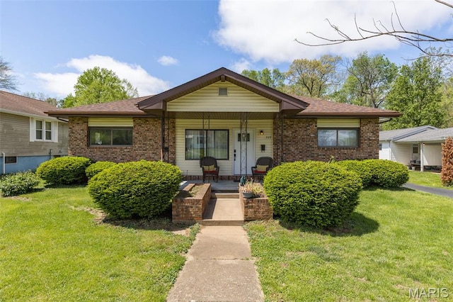 309 S A St, Farmington, MO 63640 - view of front facade featuring brick siding, a front yard, a porch, and a shingled roof