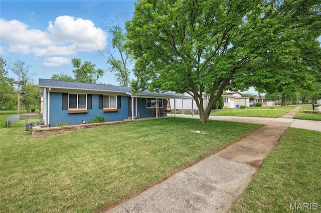 view of front of property with a front yard and brick siding