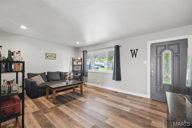living room featuring wood finished floors, baseboards, and recessed lighting