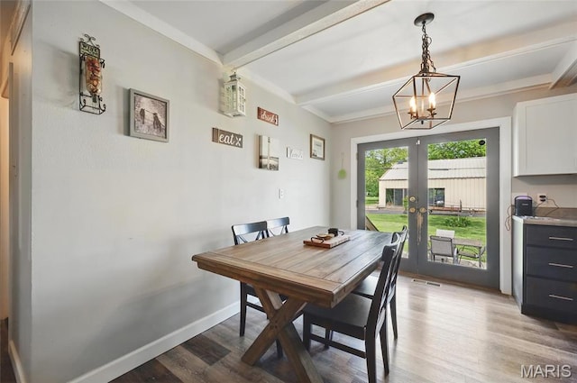 dining space featuring french doors, beam ceiling, wood finished floors, a chandelier, and baseboards