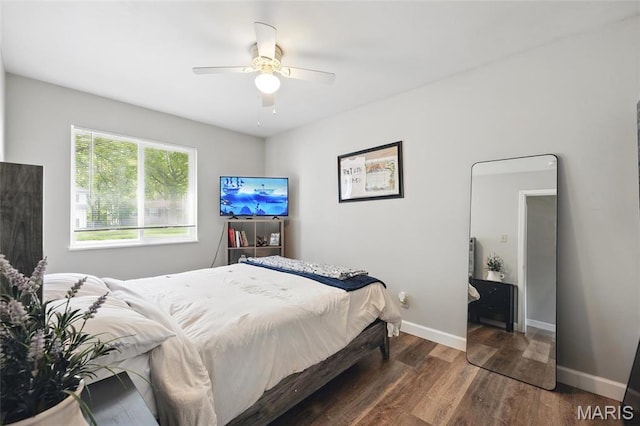 bedroom with wood finished floors, baseboards, and ceiling fan