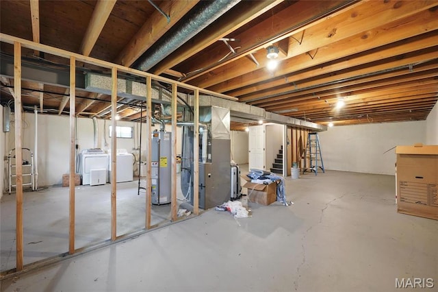 basement featuring water heater, washing machine and clothes dryer, heating unit, and stairs