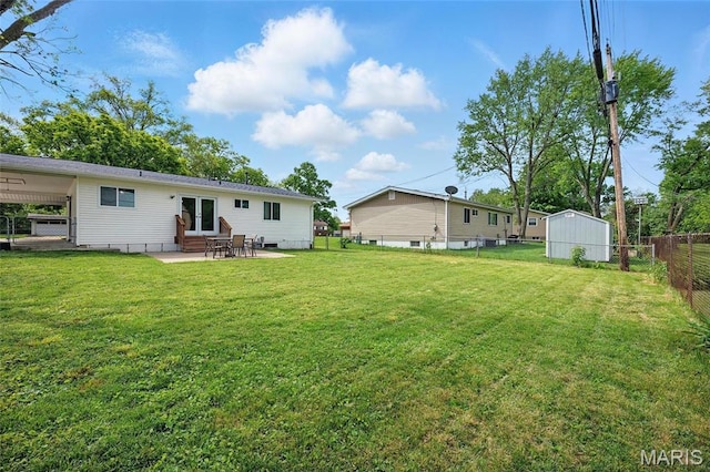 rear view of property with a patio, entry steps, french doors, an outbuilding, and a shed