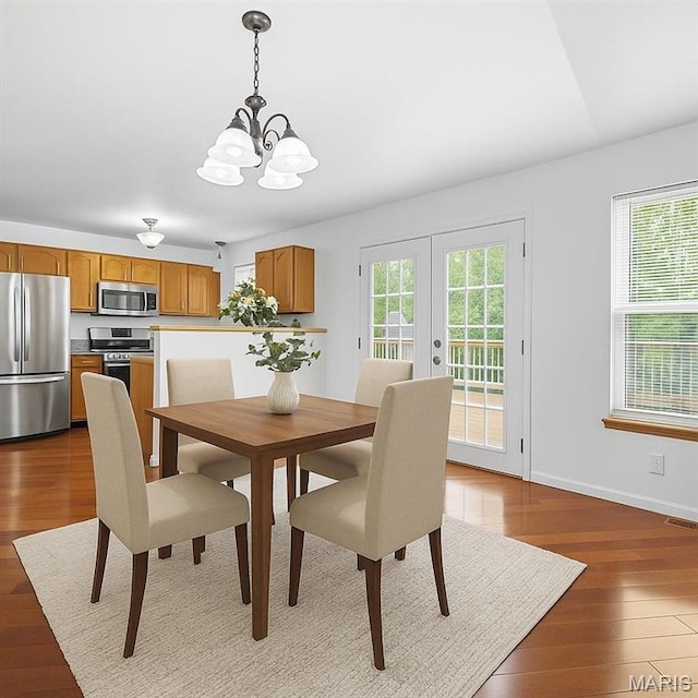 76 Eldorado Dr, Moscow Mills, MO 63362 - dining room featuring a chandelier, wood finished floors, french doors, and baseboards