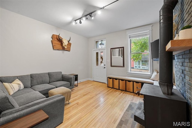 2005 Arsenal St, Saint Louis, MO 63118 - living room with a wood stove, track lighting, light wood-type flooring, and baseboards