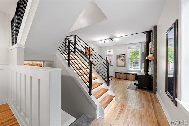 2005 Arsenal St, Saint Louis, MO 63118 - stairway with hardwood / wood-style flooring, a wood stove, and rail lighting