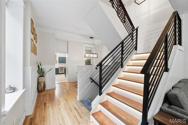 2005 Arsenal St, Saint Louis, MO 63118 - stairway with hardwood / wood-style floors, wainscoting, and a decorative wall