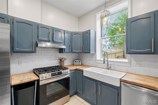 2005 Arsenal St, Saint Louis, MO 63118 - kitchen featuring stainless steel appliances, under cabinet range hood, a sink, and butcher block countertops