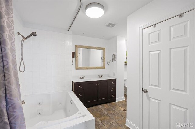 2005 Arsenal St, Saint Louis, MO 63118 - bathroom with vanity, a combined bath / shower with jetted tub, baseboards, and toilet