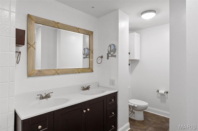 2005 Arsenal St, Saint Louis, MO 63118 - bathroom with toilet, double vanity, baseboards, and tile patterned floors
