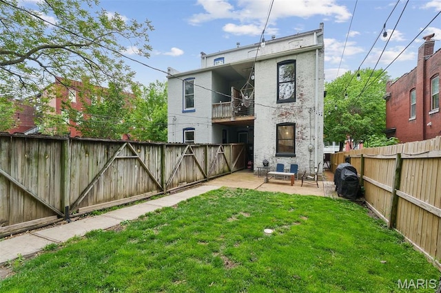 2005 Arsenal St, Saint Louis, MO 63118 - back of property featuring a patio, a balcony, and brick siding