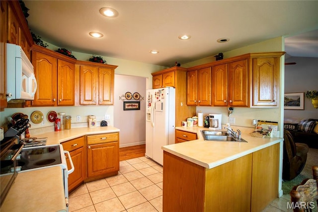 1014 Pine St, Sikeston, MO 63801 - kitchen with white appliances, a sink, light countertops, brown cabinets, and recessed lighting
