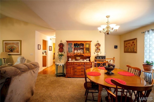 1014 Pine St, Sikeston, MO 63801 - dining space with a chandelier, light carpet, and lofted ceiling
