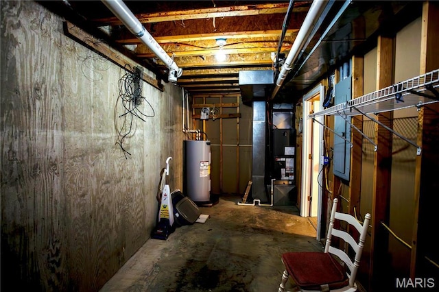 1014 Pine St, Sikeston, MO 63801 - unfinished basement featuring electric water heater and heating unit
