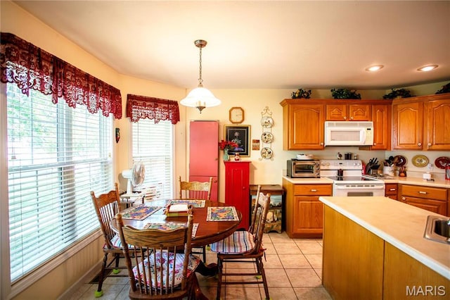 1014 Pine St, Sikeston, MO 63801 - kitchen with white appliances, plenty of natural light, light countertops, light tile patterned floors, and recessed lighting