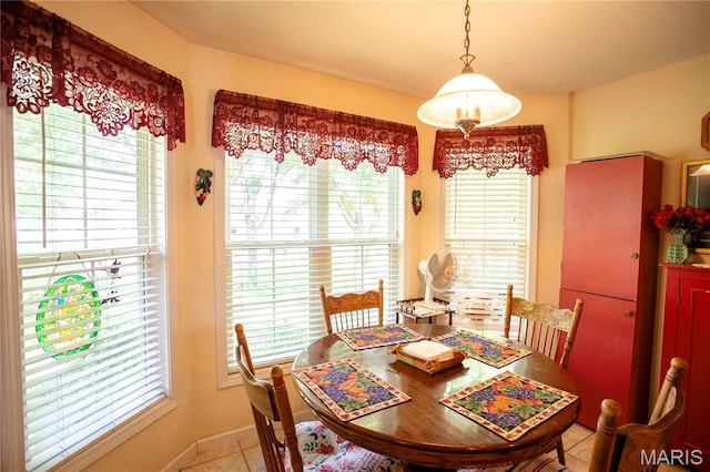 1014 Pine St, Sikeston, MO 63801 - dining area with plenty of natural light, light tile patterned floors, and baseboards