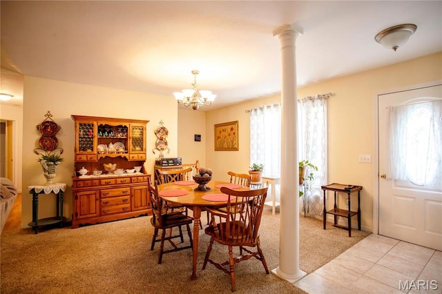 1014 Pine St, Sikeston, MO 63801 - dining room featuring light carpet, decorative columns, a chandelier, and light tile patterned flooring