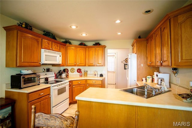 1014 Pine St, Sikeston, MO 63801 - kitchen featuring white appliances, a sink, brown cabinets, and recessed lighting